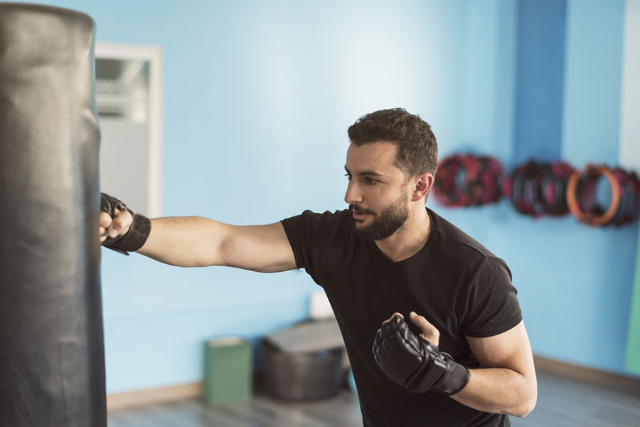 A bearded man exercises at gym